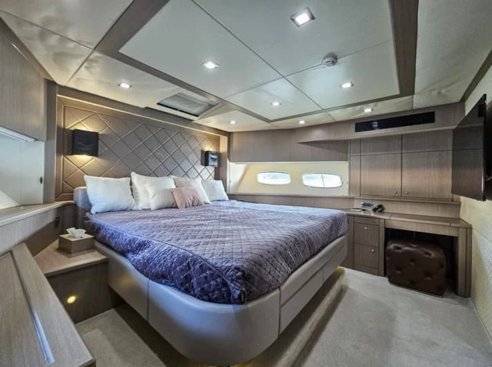 a bedroom with a bed and a fireplace aboard TURQUOISE Yacht for Sale