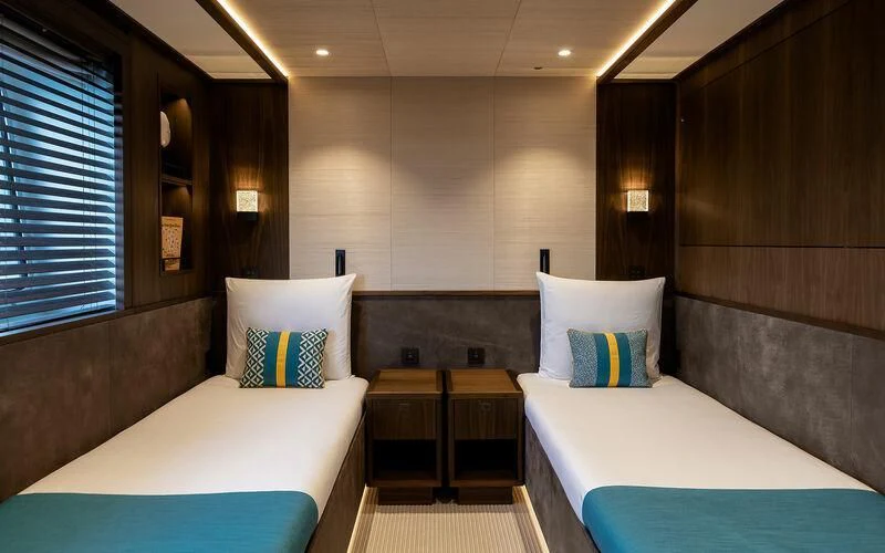 a room with beds and a table aboard JOSEPHINE I Yacht for Sale