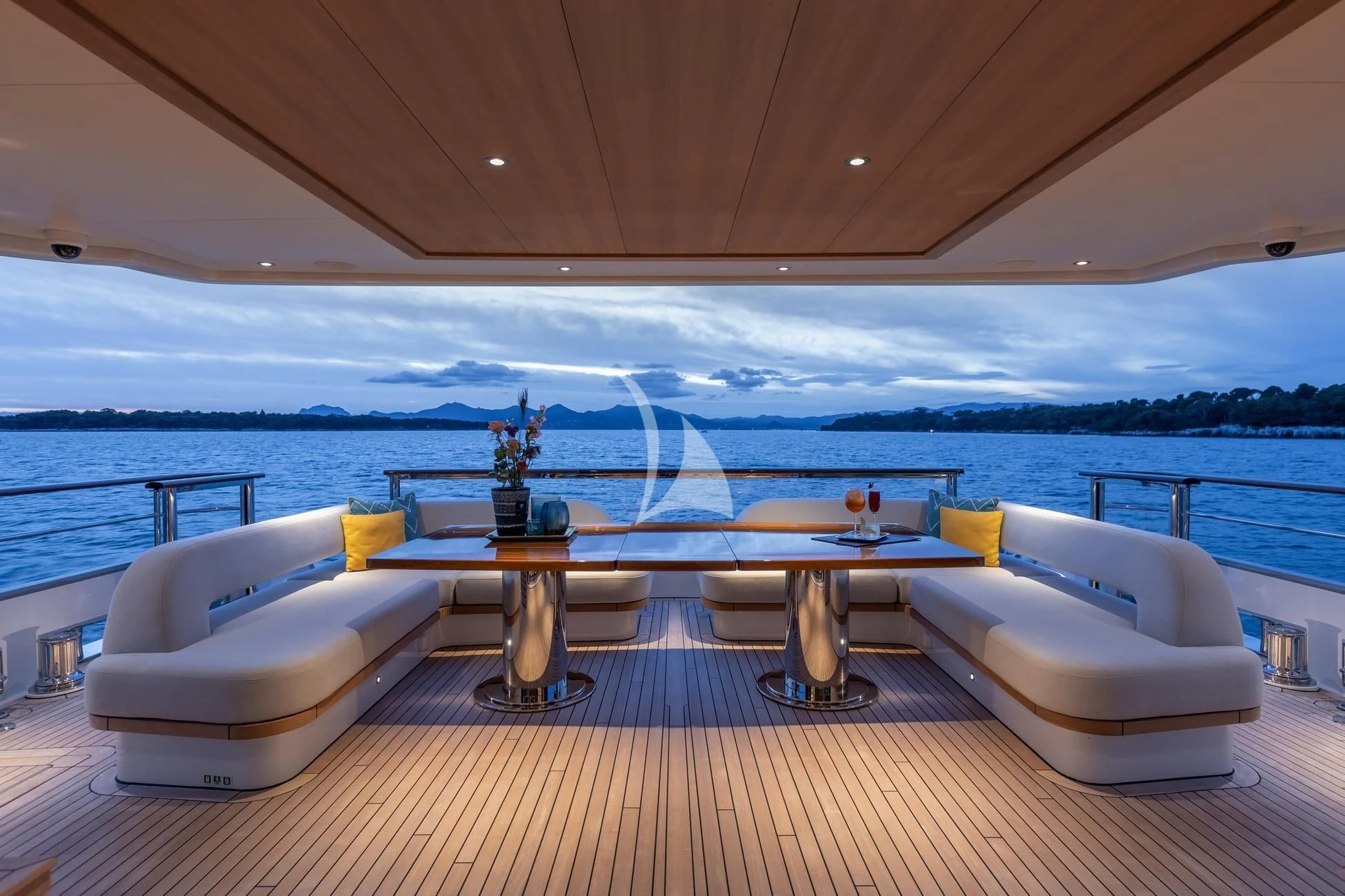 a room with a table and chairs on a deck overlooking the ocean aboard JOSEPHINE I Yacht for Sale