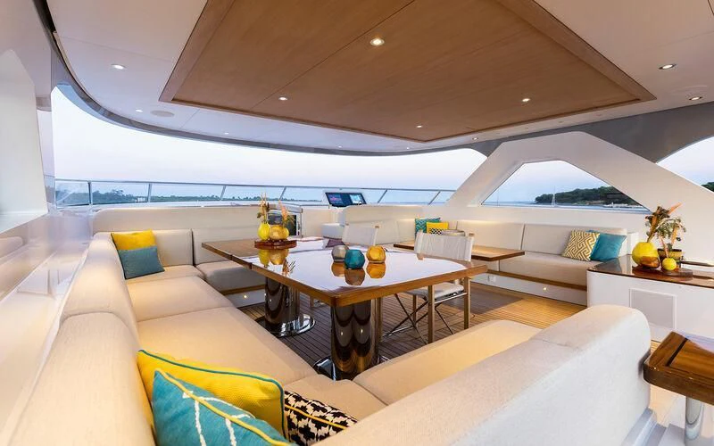 a living room with a large table aboard JOSEPHINE I Yacht for Sale
