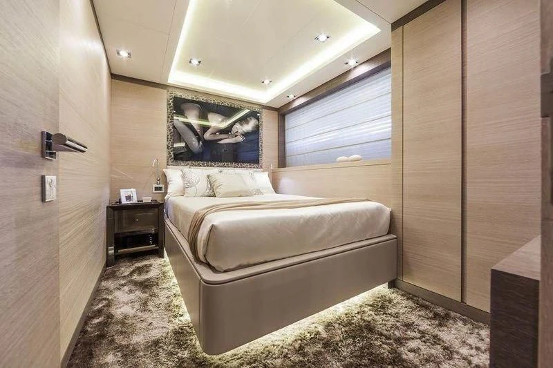 a bedroom with a bed and a dresser aboard PANTHERA Yacht for Sale