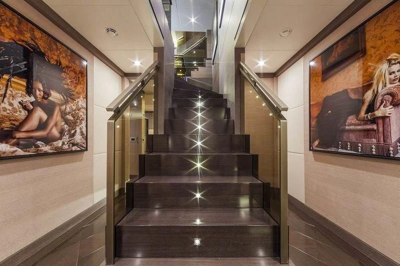a hallway with paintings on the wall aboard PANTHERA Yacht for Sale