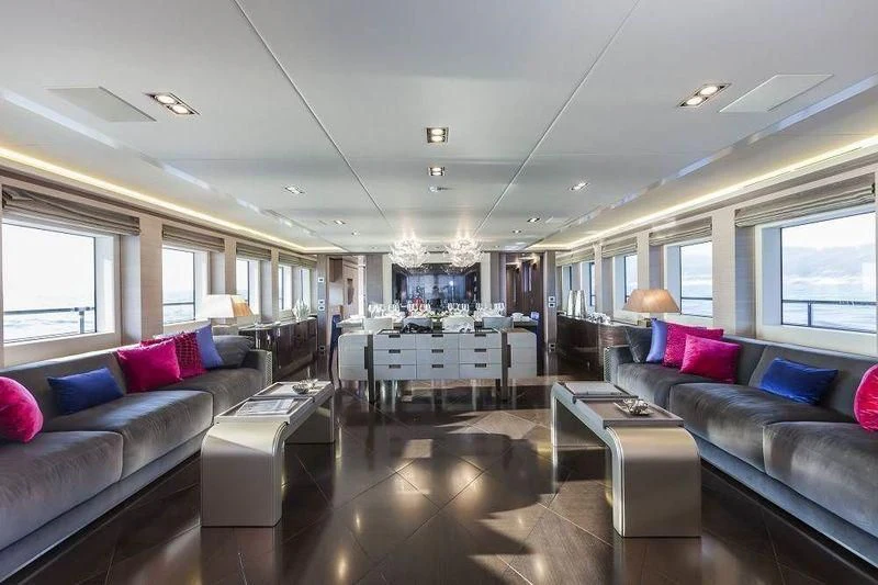 a living room with a large glass table and a couch aboard PANTHERA Yacht for Sale
