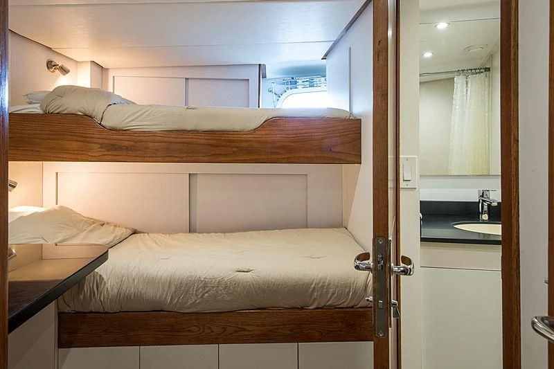 a bedroom with a bed and a sink aboard GRACE Yacht for Sale