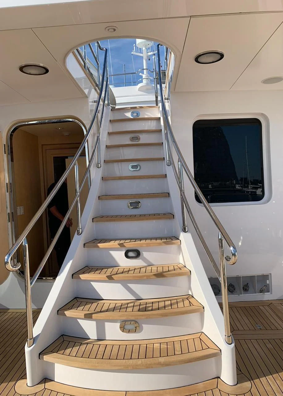 a large metal staircase in a room aboard GRACE Yacht for Sale