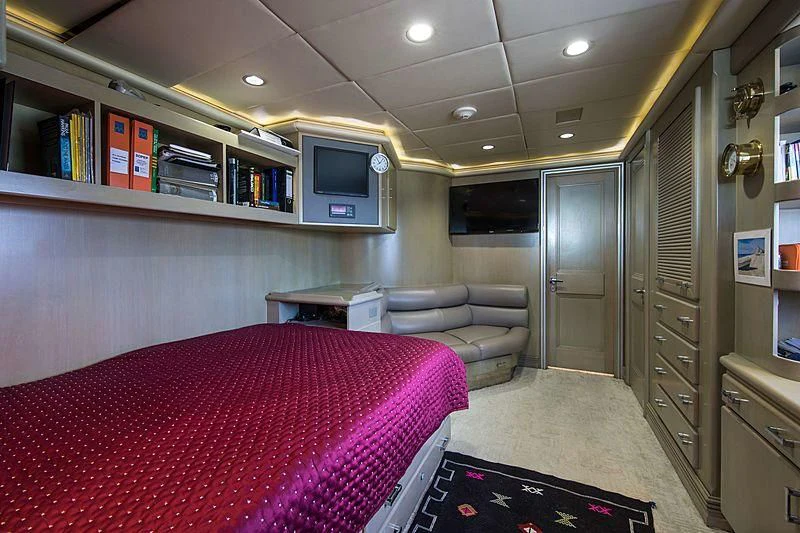 a bedroom with a bed and a desk aboard GRACE Yacht for Sale