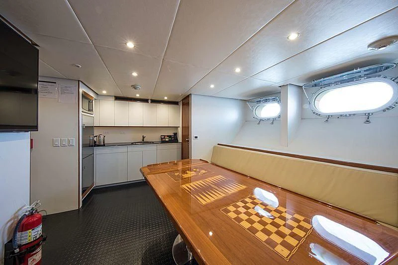 a large kitchen with a wood table aboard GRACE Yacht for Sale