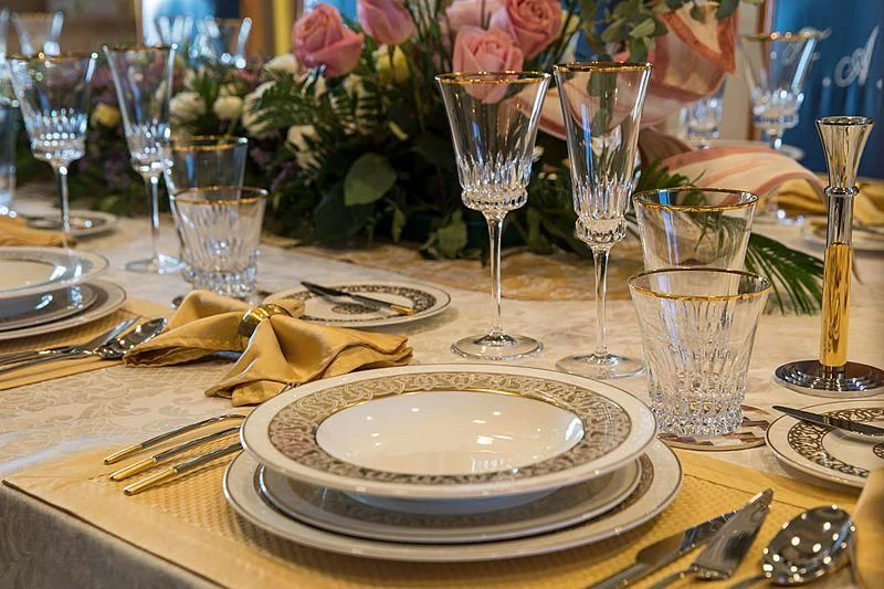 a table with plates and glasses aboard GRACE Yacht for Sale