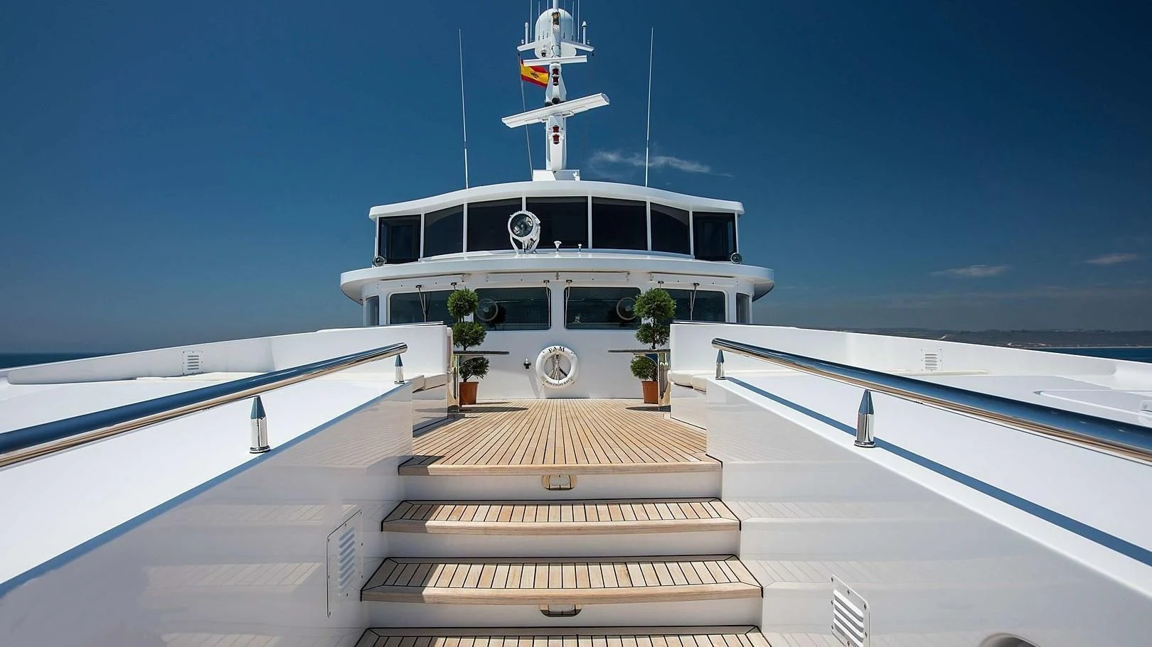 a white house with a white roof and a white tower on a sunny day aboard GRACE Yacht for Sale