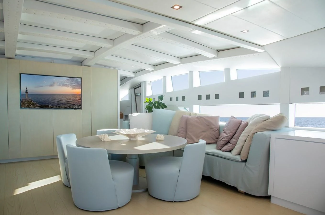a room with a couch and a table and chairs aboard BLUE PRINCESS STAR Yacht for Sale