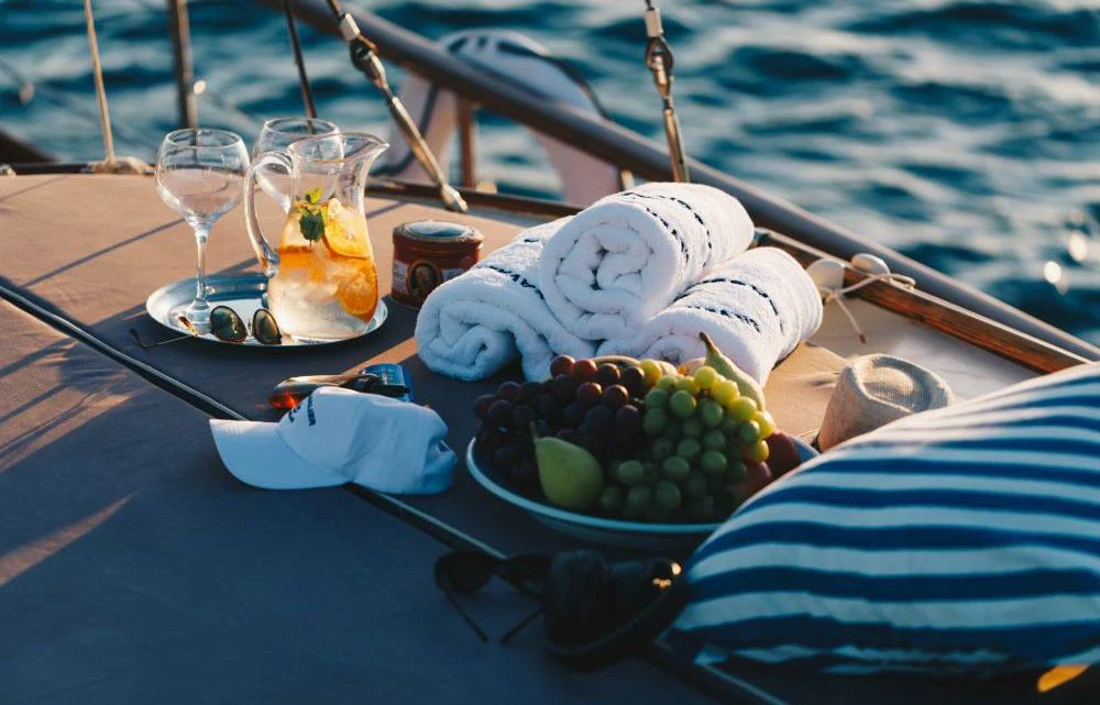 a plate of food and drinks on a table aboard SILVER CAVALIER Yacht for Sale