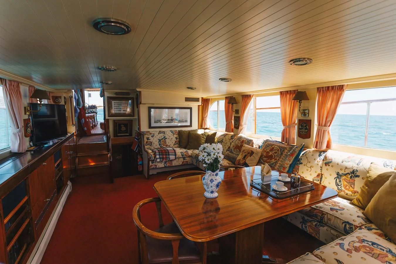 a living room with a table and couches aboard SILVER CAVALIER Yacht for Sale