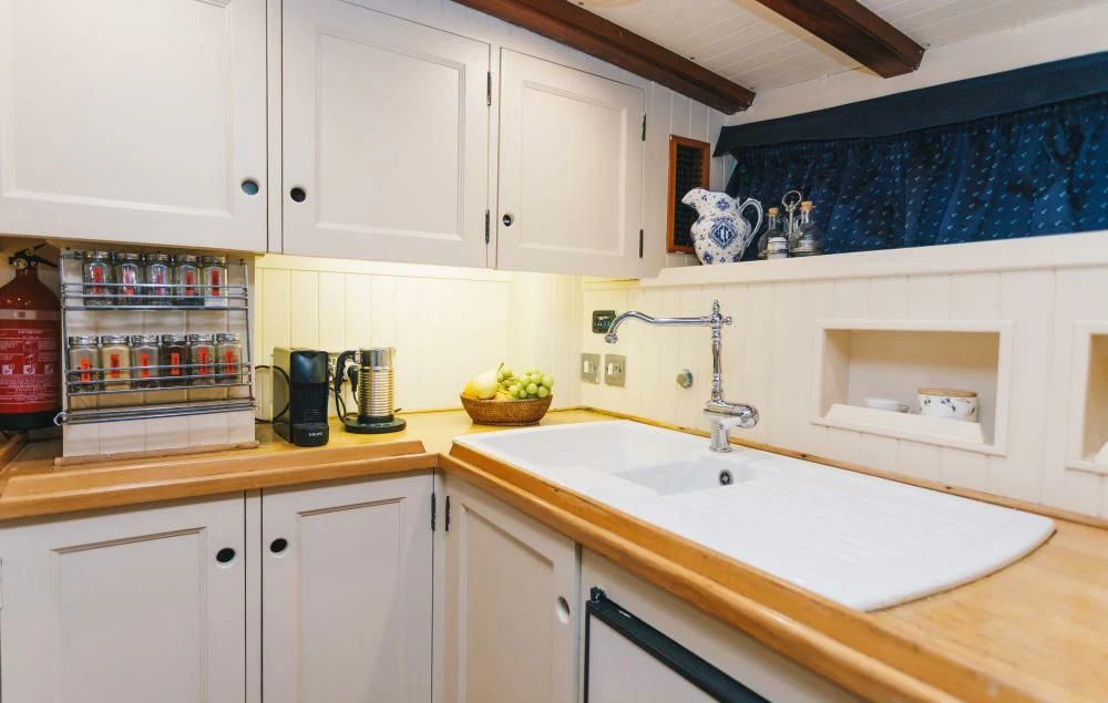 a kitchen with white cabinets aboard SILVER CAVALIER Yacht for Sale