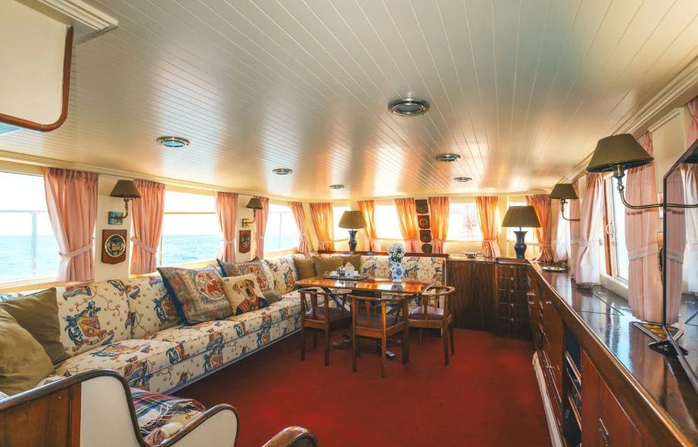 a living room with a couch and a table aboard SILVER CAVALIER Yacht for Sale