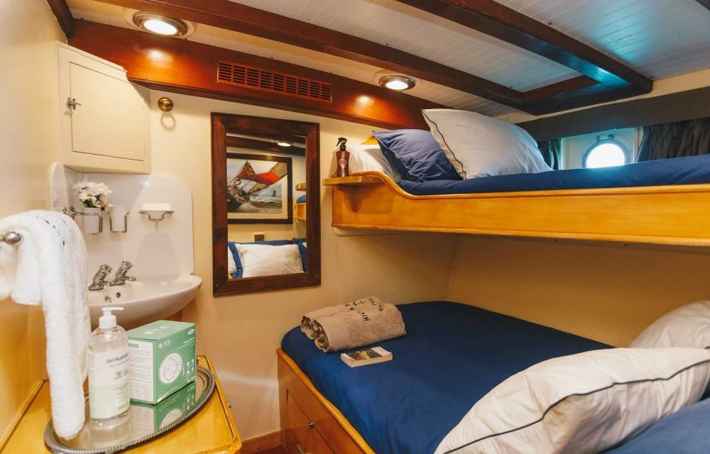 a small bedroom with a bed aboard SILVER CAVALIER Yacht for Sale