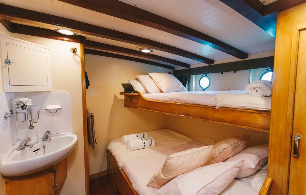 a small bedroom with a bed aboard SILVER CAVALIER Yacht for Sale