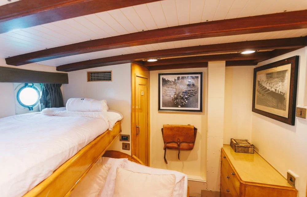 a room with a bed and a chair aboard SILVER CAVALIER Yacht for Sale
