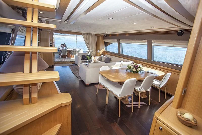 a room with a table and chairs aboard YOYITA Yacht for Sale