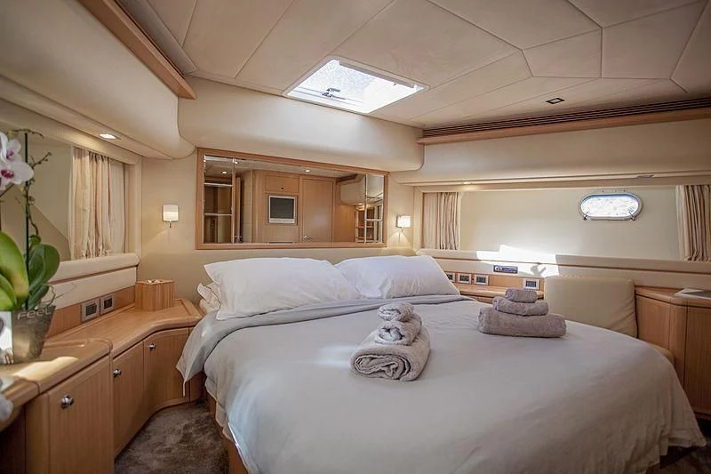 a bedroom with two beds aboard YOYITA Yacht for Sale