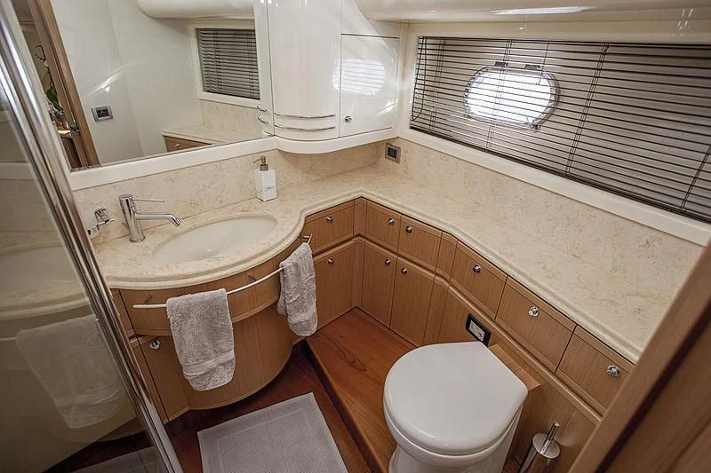 a bathroom with wooden cabinets aboard YOYITA Yacht for Sale
