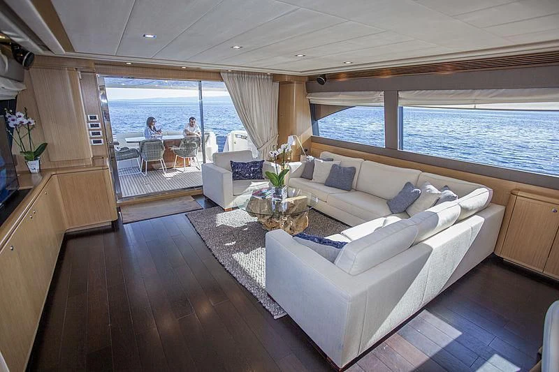 a living room with a large window aboard YOYITA Yacht for Sale