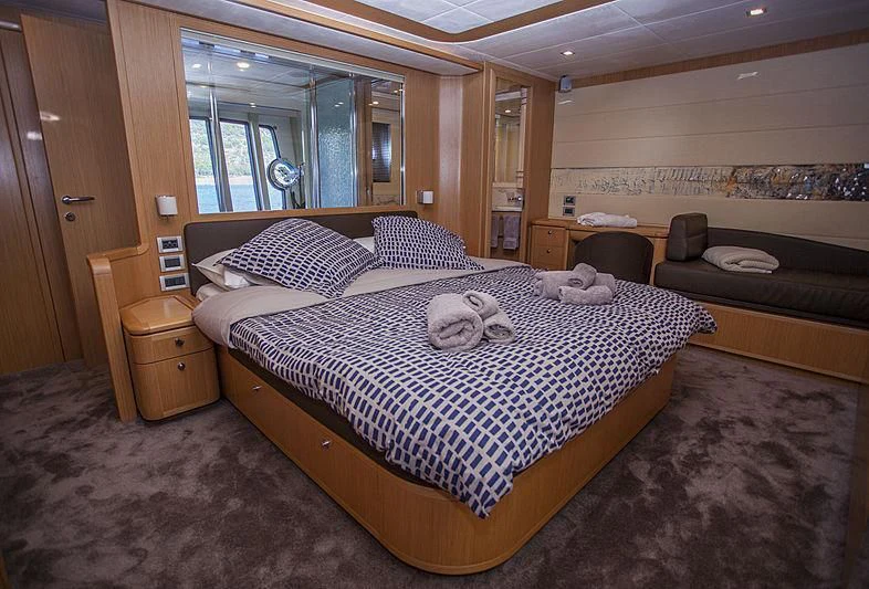 a bedroom with a large bed aboard YOYITA Yacht for Sale