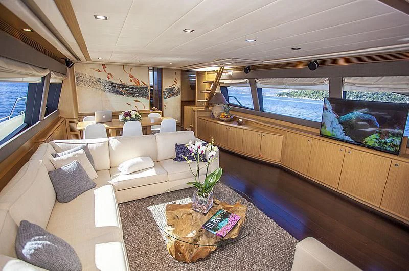 a living room with a large window aboard YOYITA Yacht for Sale