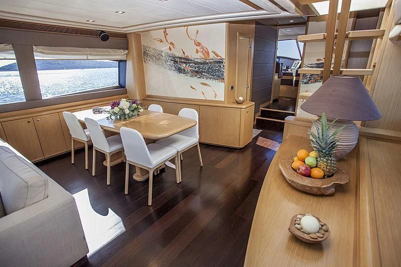 a room with a table and chairs aboard YOYITA Yacht for Sale