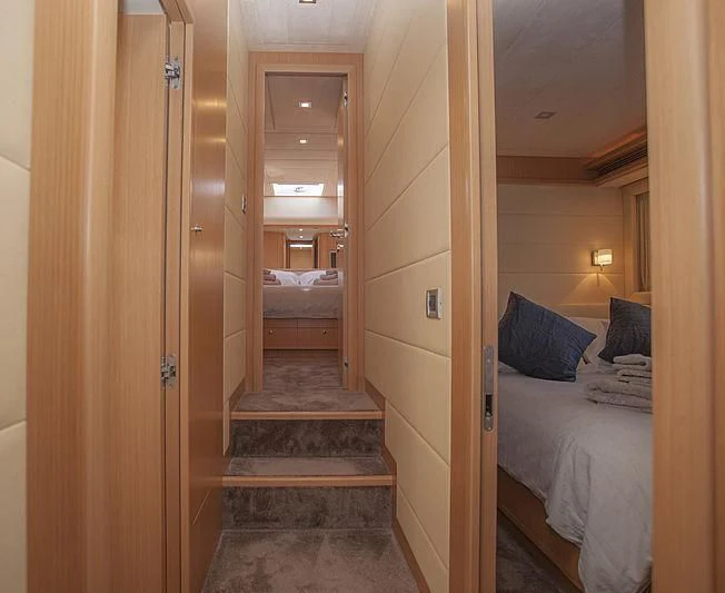 a room with a bed and a door aboard YOYITA Yacht for Sale