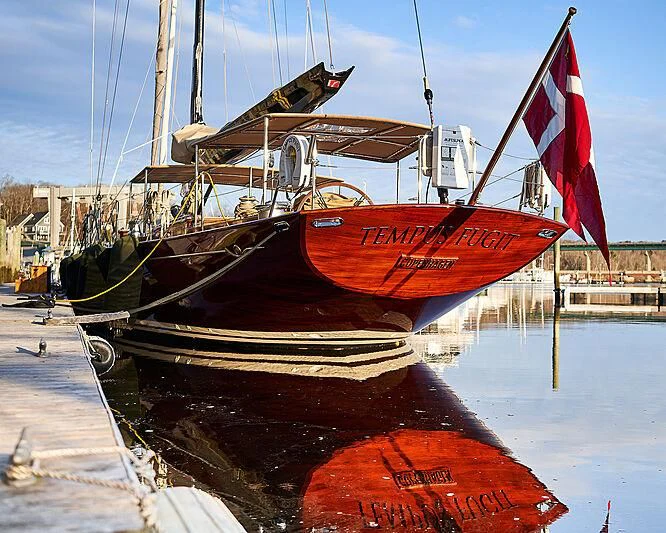 a boat with a flag on it aboard TEMPUS FUGIT Yacht for Sale