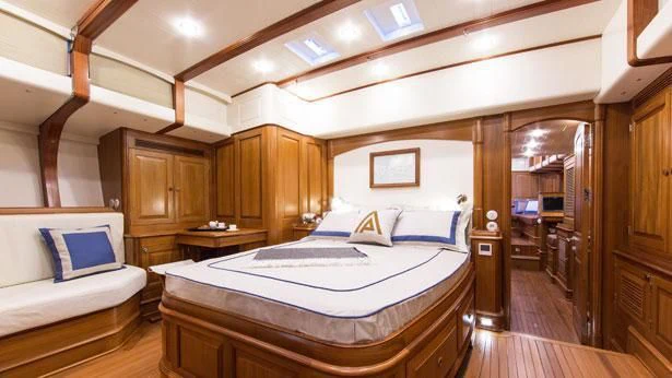 a bedroom with a bed and a desk aboard TEMPUS FUGIT Yacht for Sale