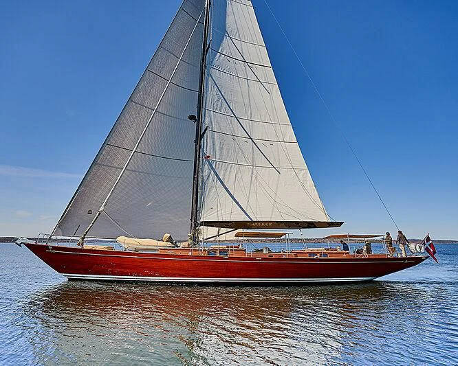 a large sailboat on the water aboard TEMPUS FUGIT Yacht for Sale