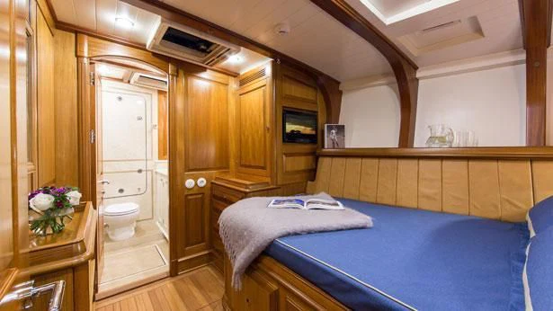a bedroom with a bed and a desk aboard TEMPUS FUGIT Yacht for Sale
