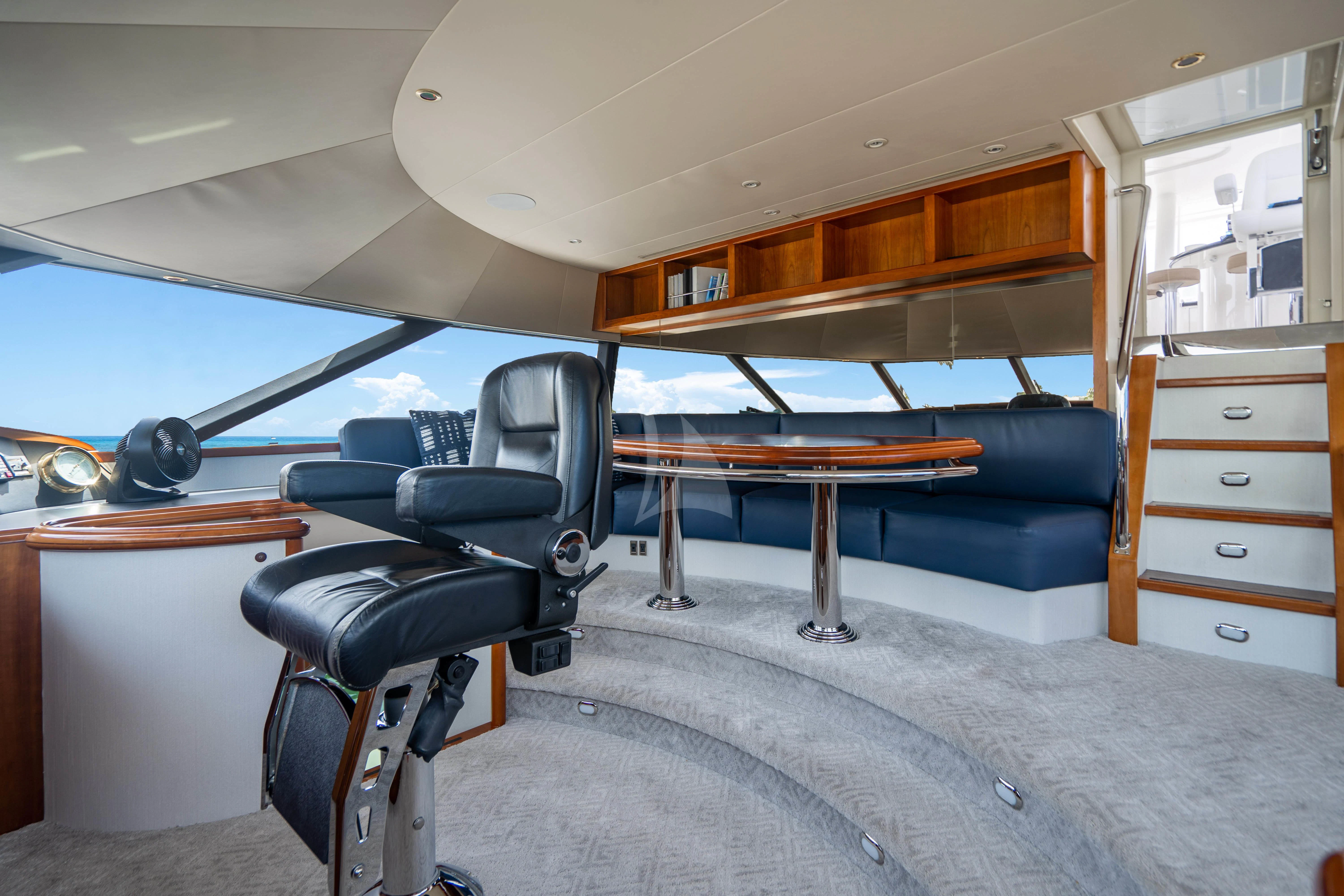 a room with a couch and a table and a chair aboard LILA CUY Yacht for Sale
