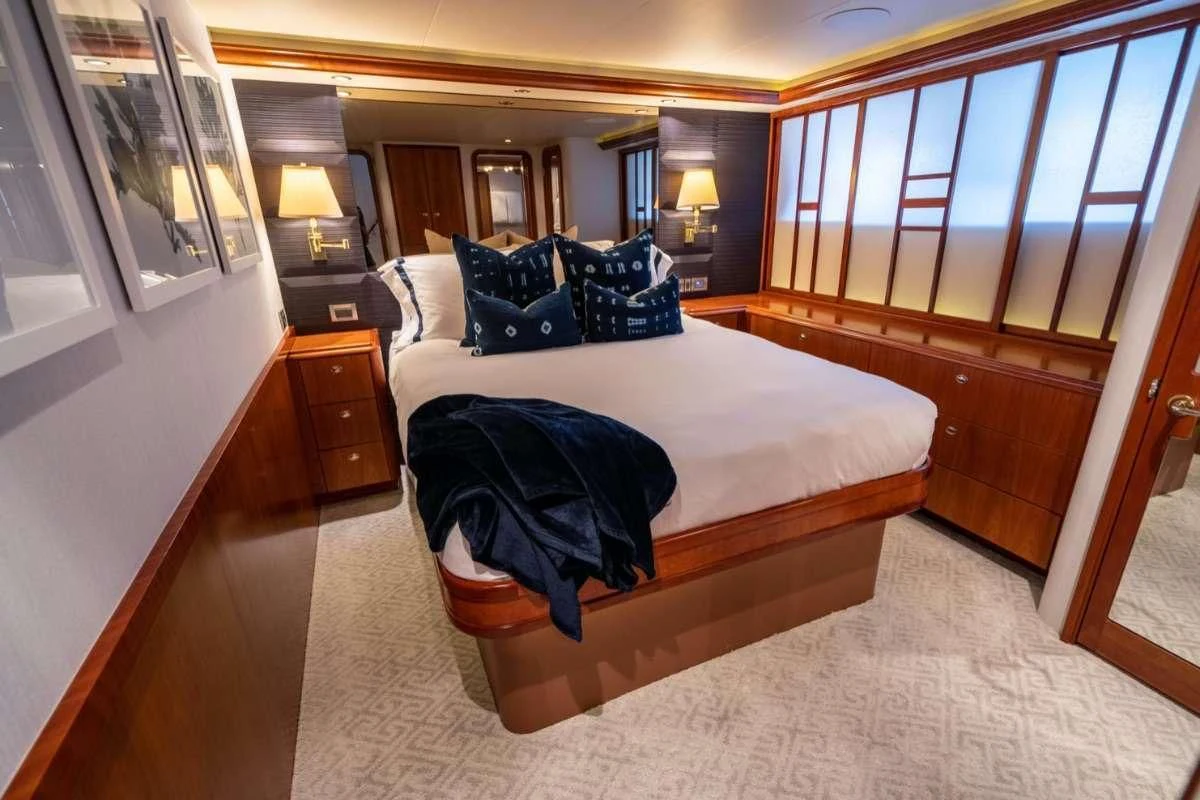 a hotel room with a bed and a desk aboard LILA CUY Yacht for Sale