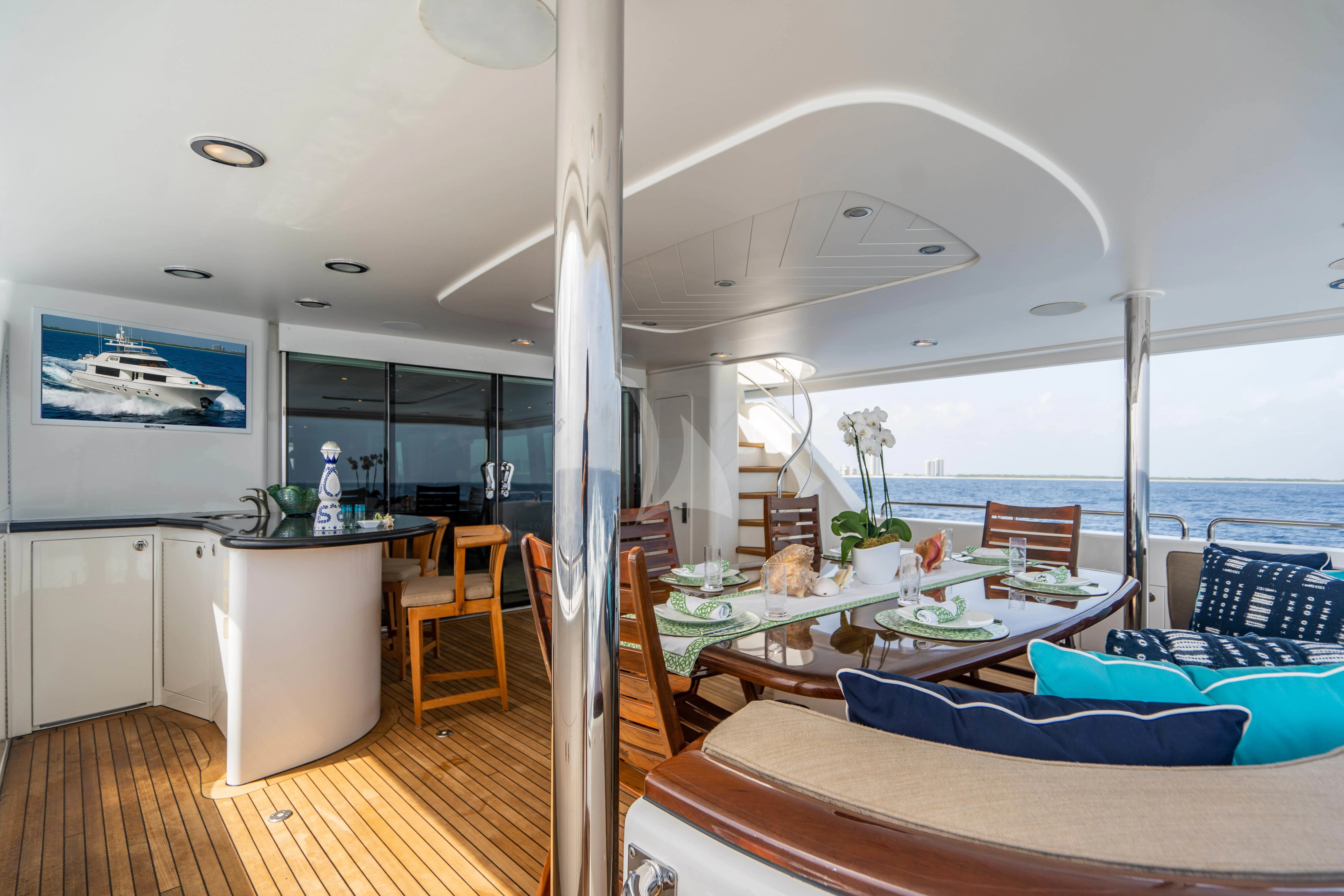 a room with a table and chairs aboard LILA CUY Yacht for Sale