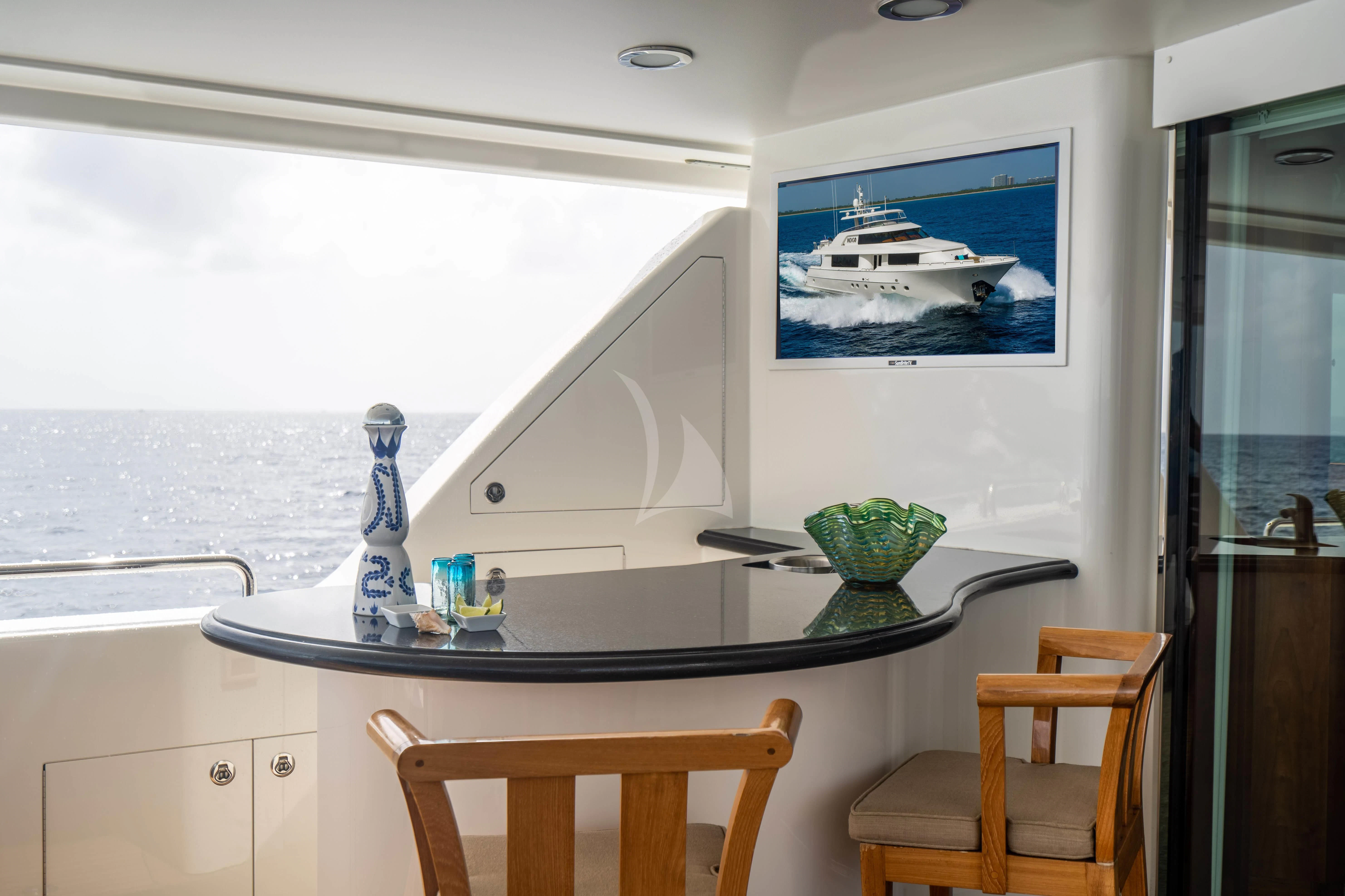 a kitchen with a table and chairs aboard LILA CUY Yacht for Sale