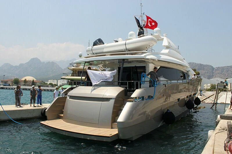 a boat with a flag on the front aboard OZONE Yacht for Sale