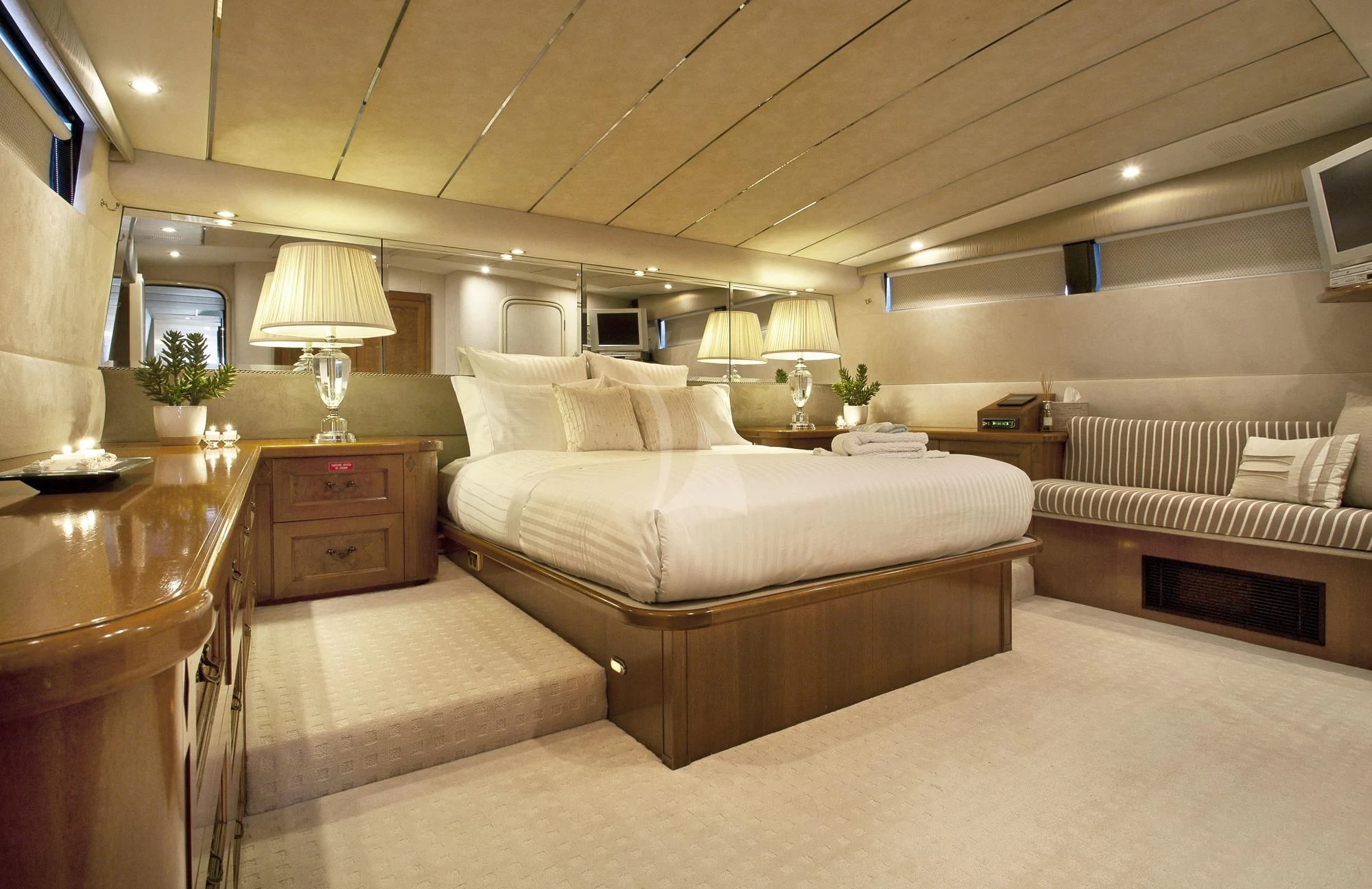 a large bedroom with a bed and a desk aboard OSCAR II Yacht for Sale