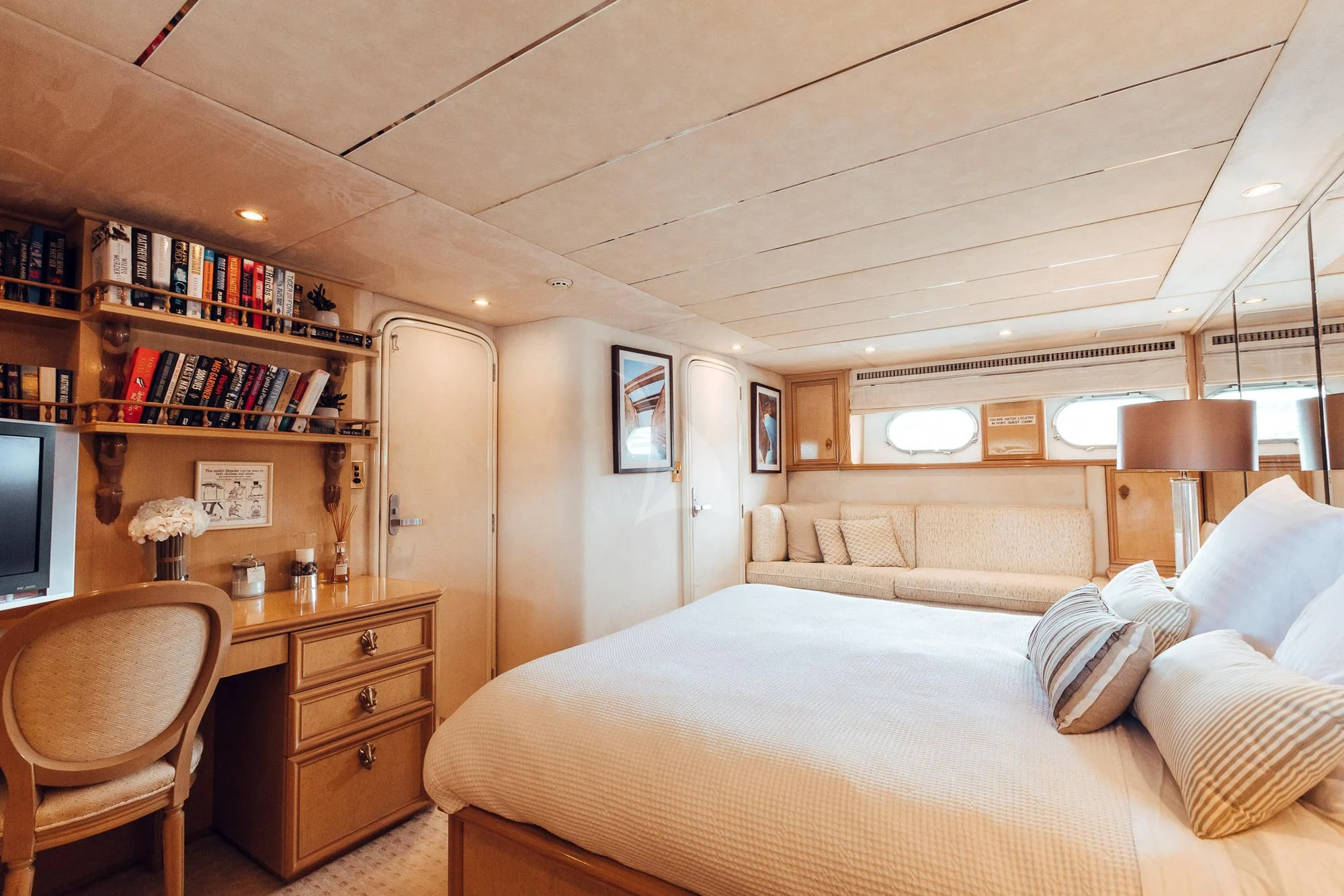 a bedroom with a bed and a desk aboard OSCAR II Yacht for Sale
