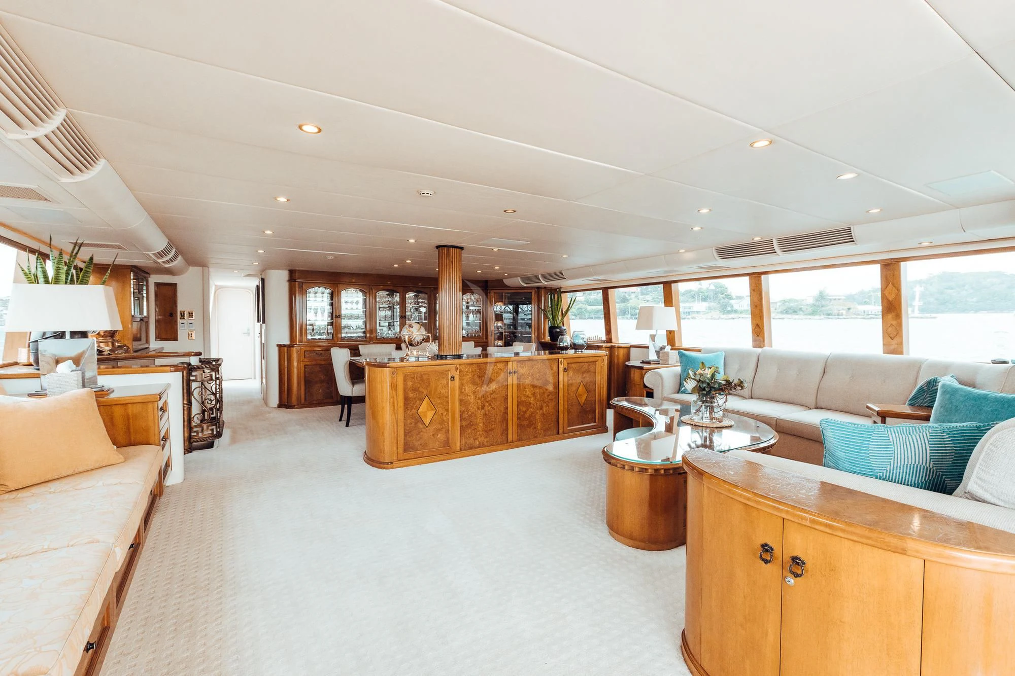 a large living room with a kitchen and dining area aboard OSCAR II Yacht for Sale