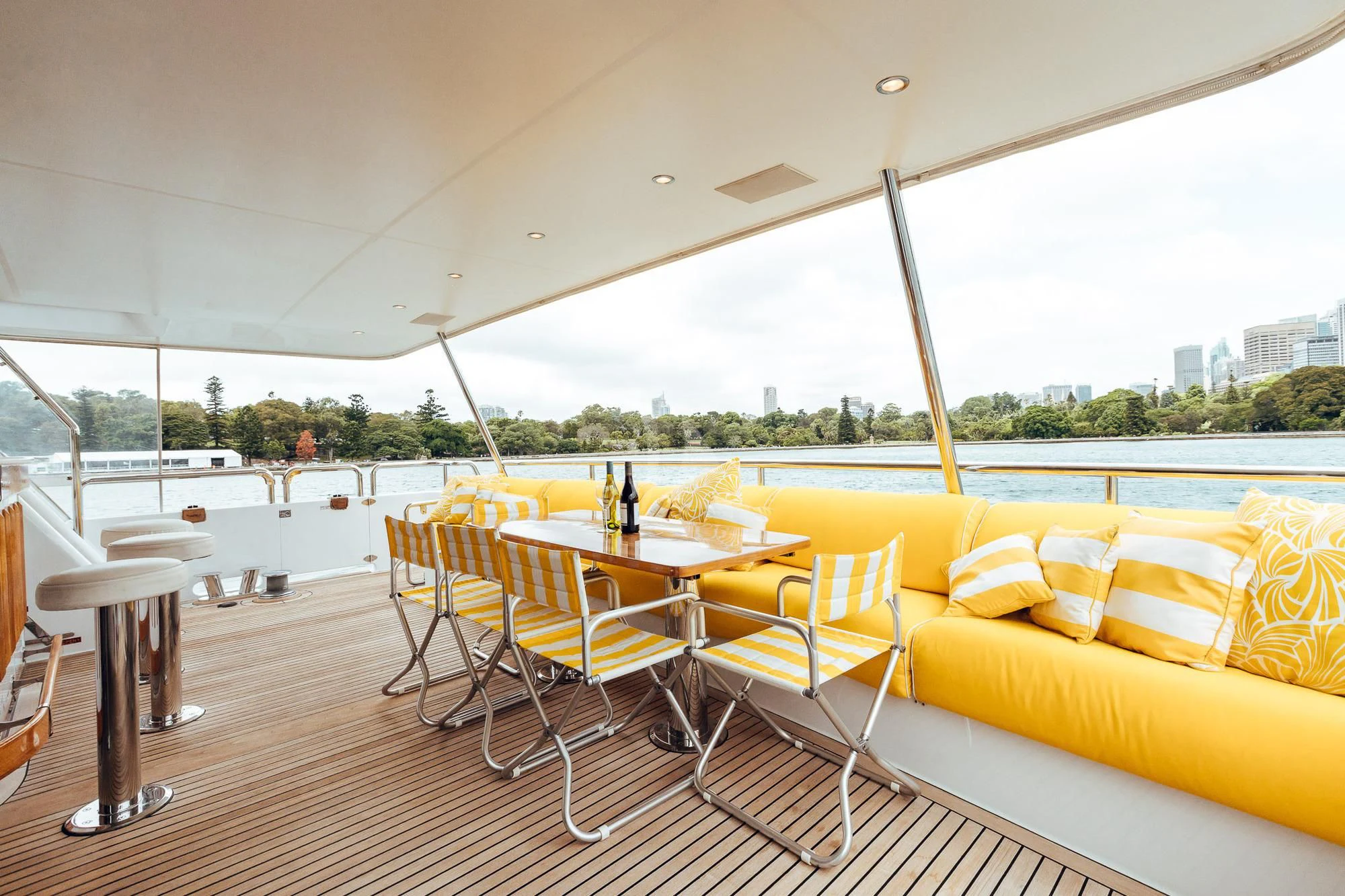 a table and chairs on a deck aboard OSCAR II Yacht for Sale