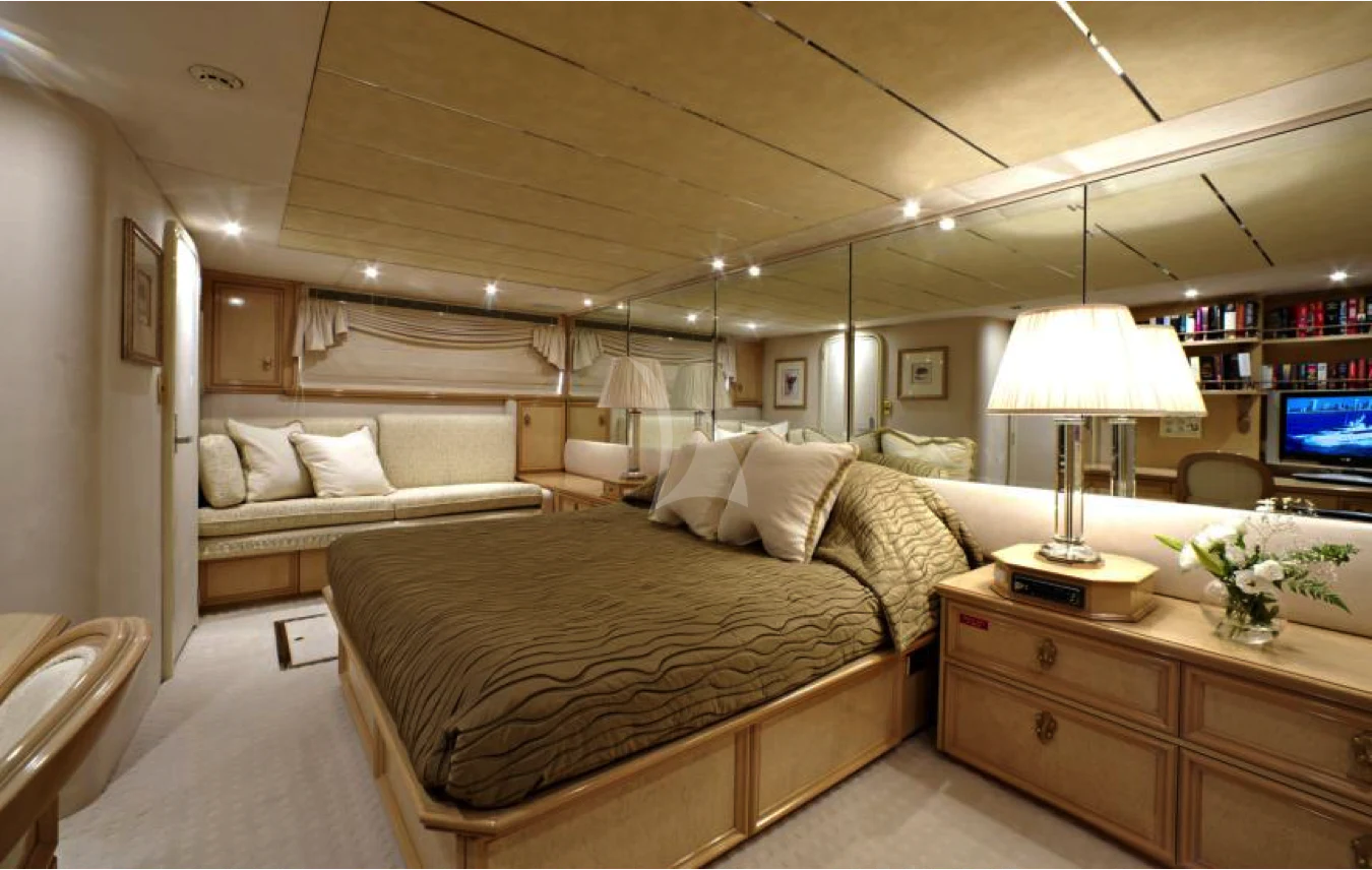 a bedroom with a bed and a desk aboard OSCAR II Yacht for Sale