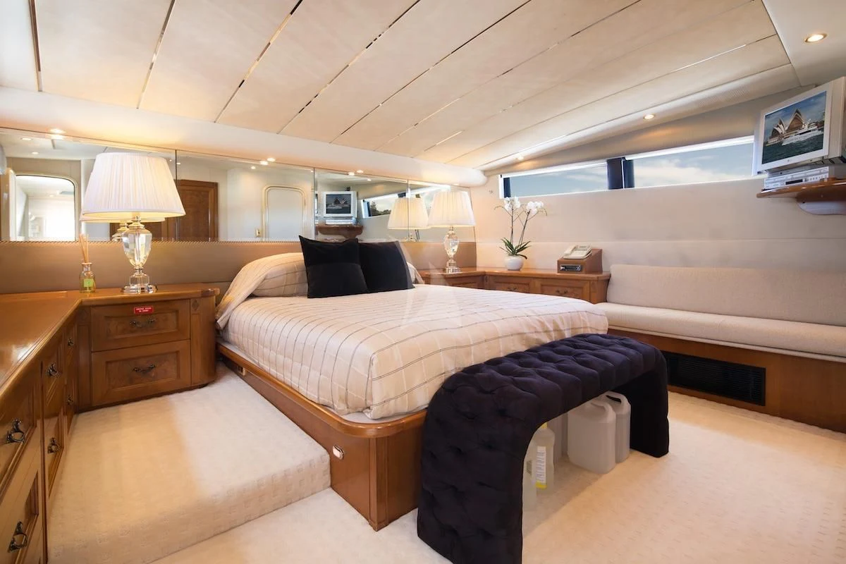 a bedroom with a bed and a desk aboard OSCAR II Yacht for Sale