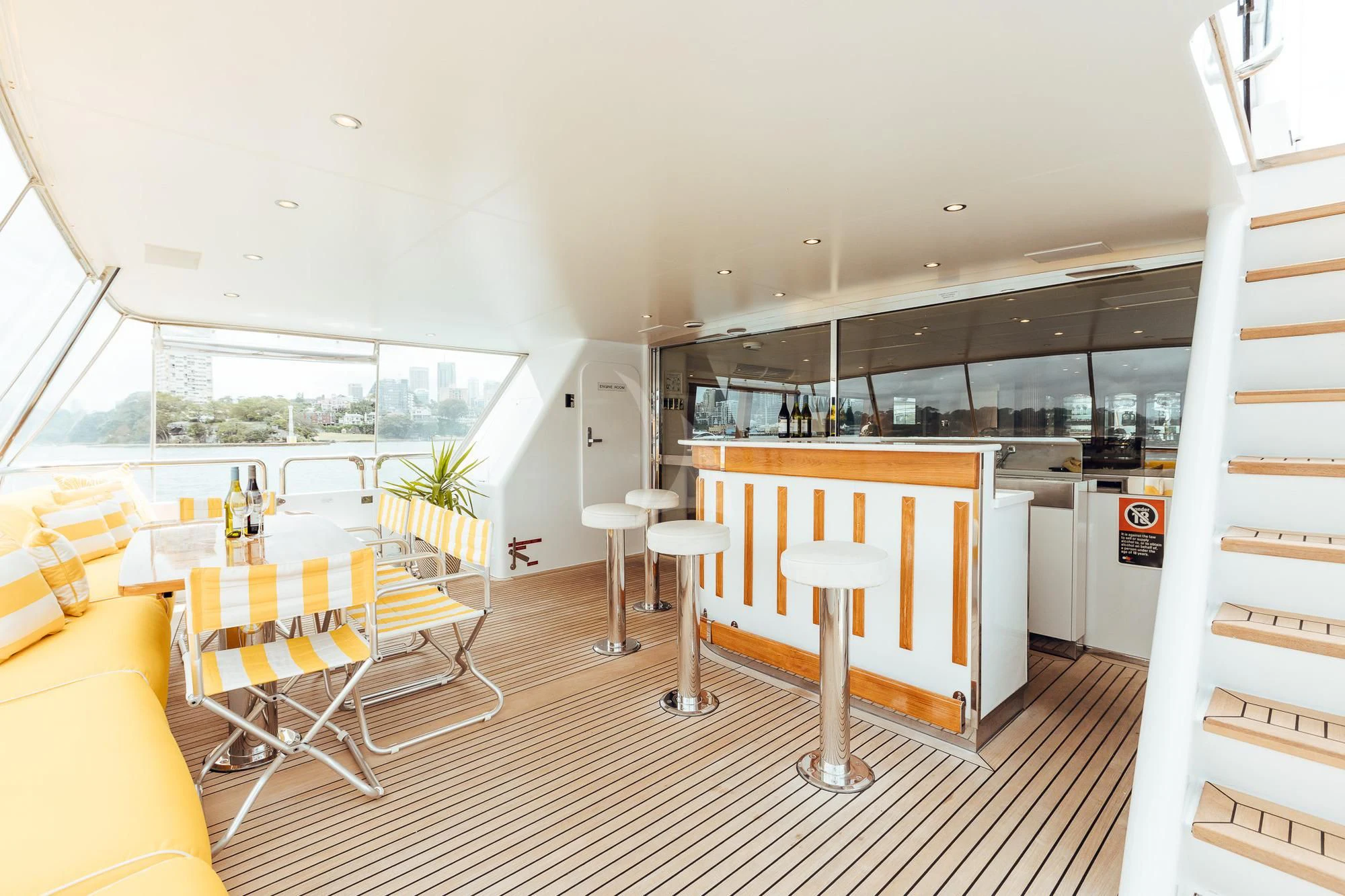 a room with tables and chairs aboard OSCAR II Yacht for Sale