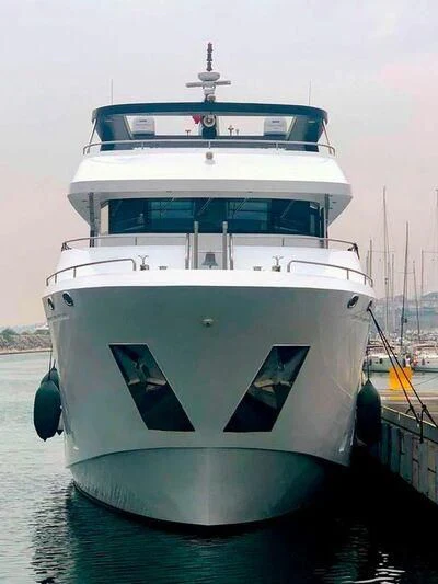 a white and blue boat aboard IVAR Yacht for Sale
