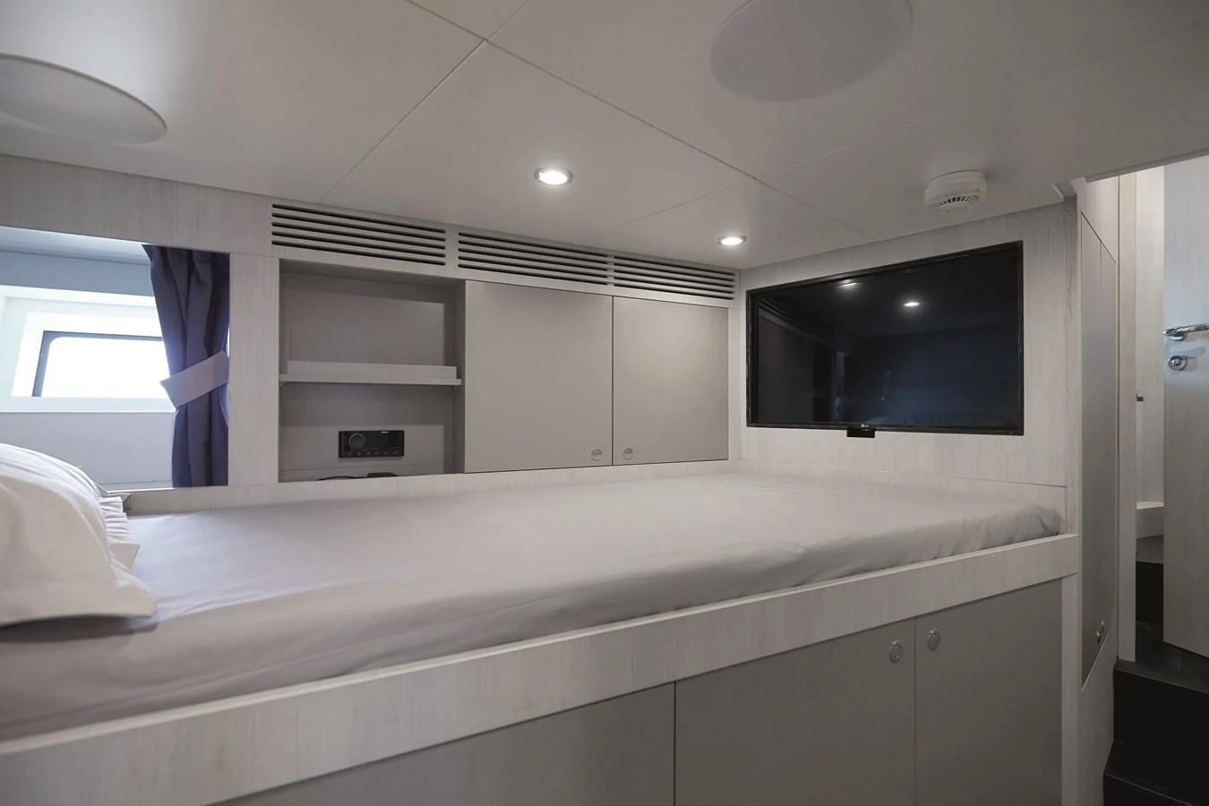 a room with a tv and a shelf with a bookcase aboard R.DARENBEN Yacht for Sale