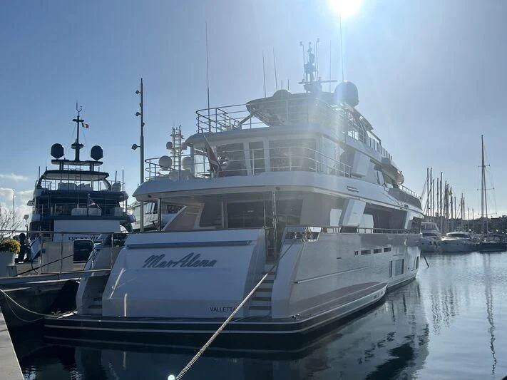 a large white boat in a harbor aboard MARALENA Yacht for Sale