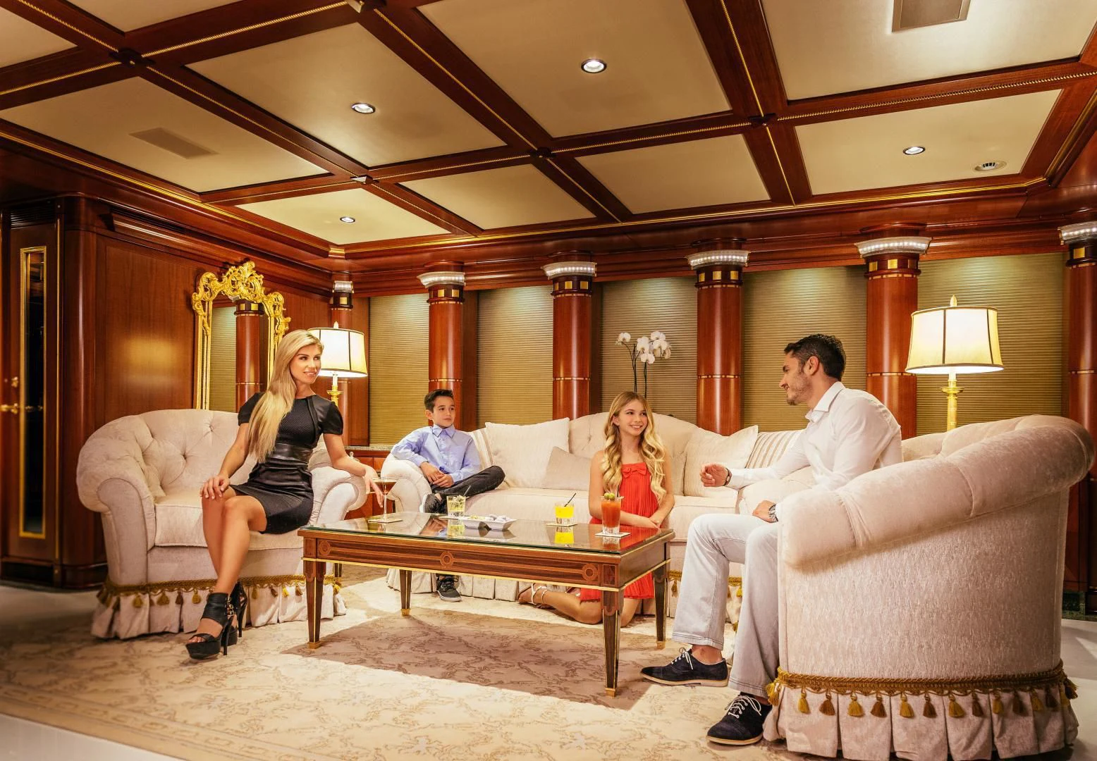 a group of people sitting around a table aboard STARSHIP Yacht for Charter