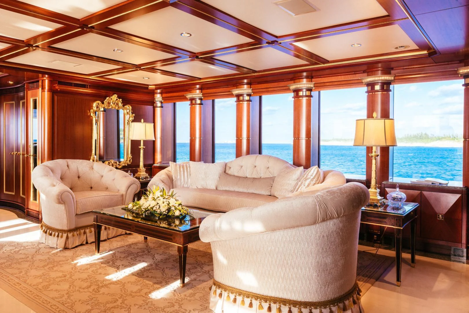 a living room with a large window aboard STARSHIP Yacht for Charter